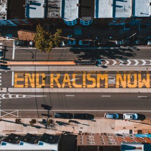 Photo by Kelly on <a href="https://www.pexels.com/photo/roadway-with-end-racism-now-title-in-town-4642503/" rel="nofollow">Pexels.com</a>